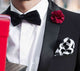 black bow tie with white pocket square and red lapel pin