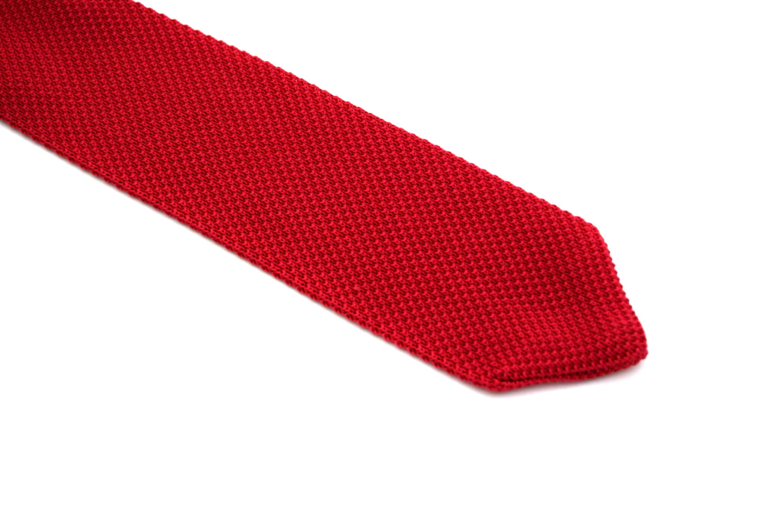 Red knitted tie on a white background
