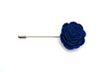 Blue rose-shaped lapel pin on a white background
