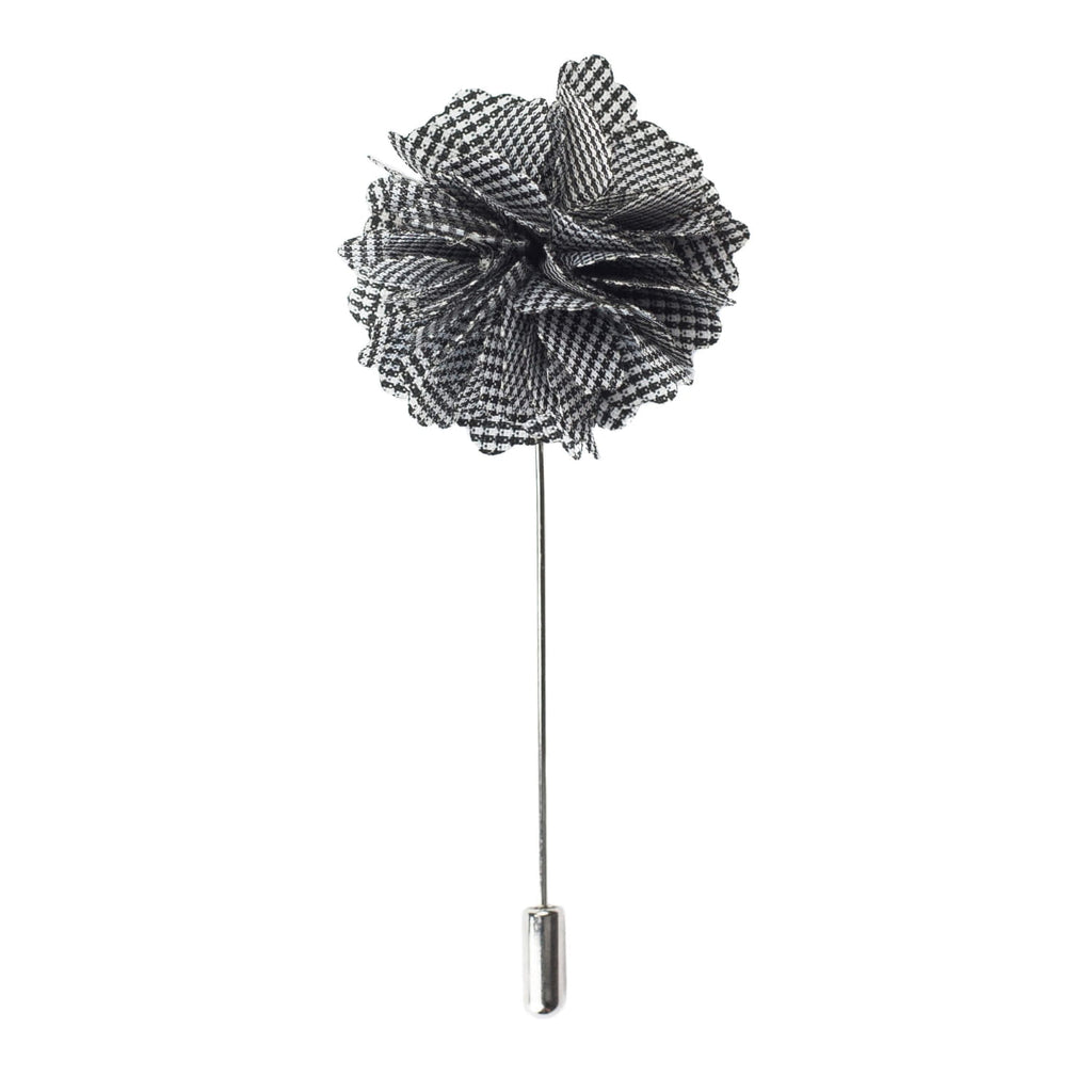 Black and white checkered flower lapel pin on a white background