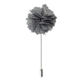 Black and white checkered flower lapel pin on a white background