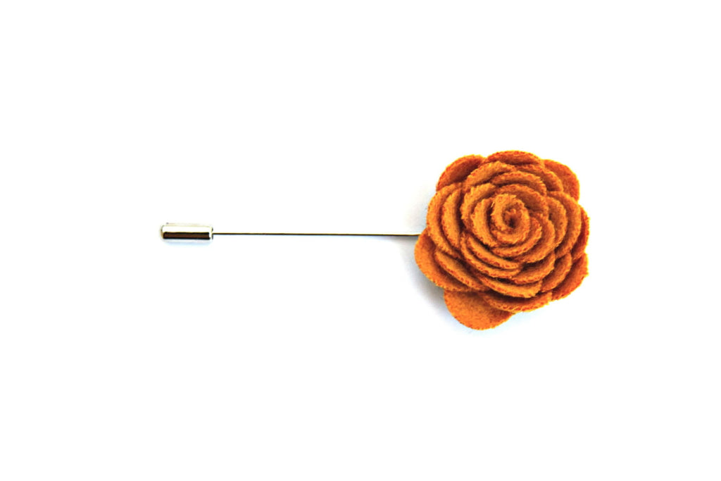 Orange flower-shaped lapel pin on a white background