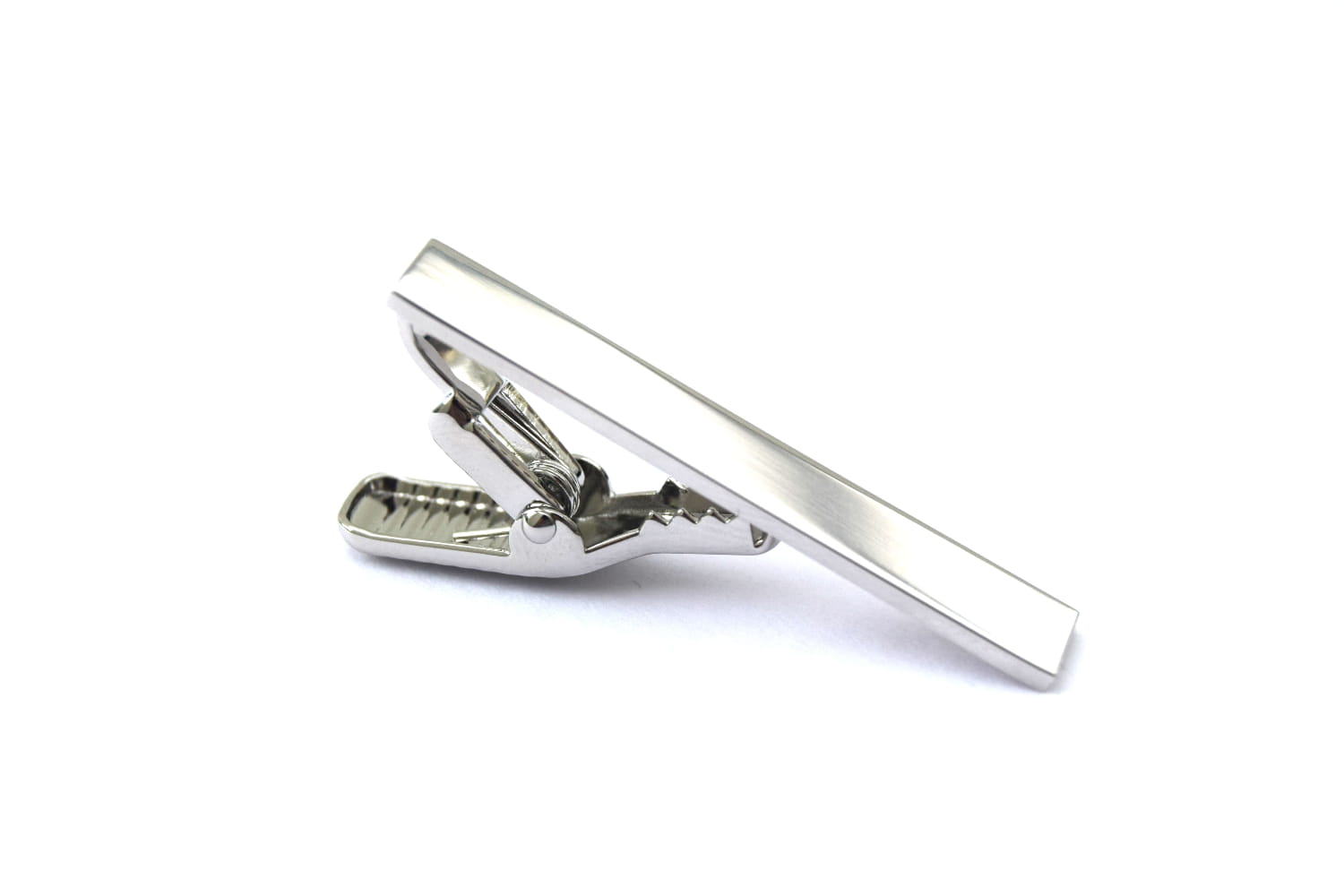 A silver tie clip against a white background