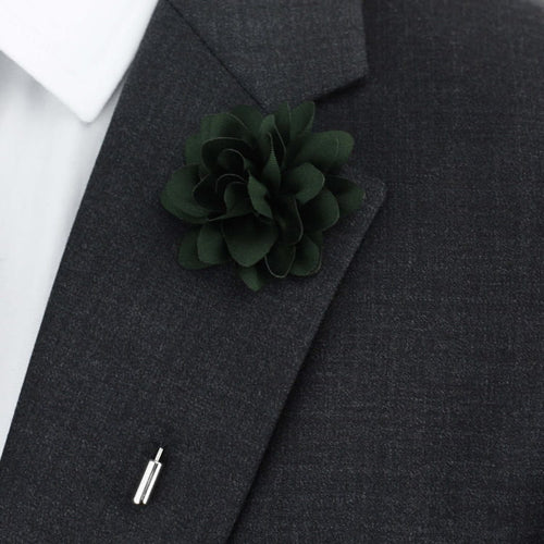 Dark green flower lapel pin on a gray suit jacket