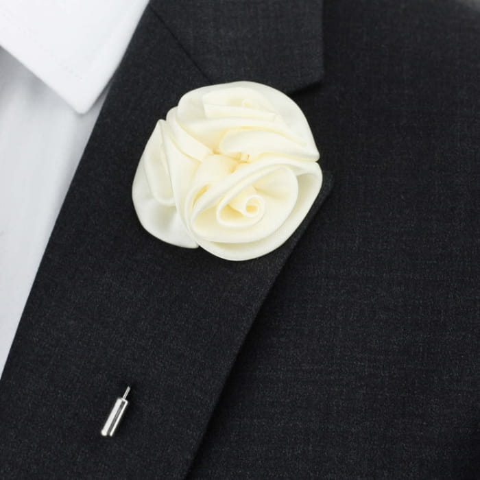 White rose boutonniere on a black suit jacket