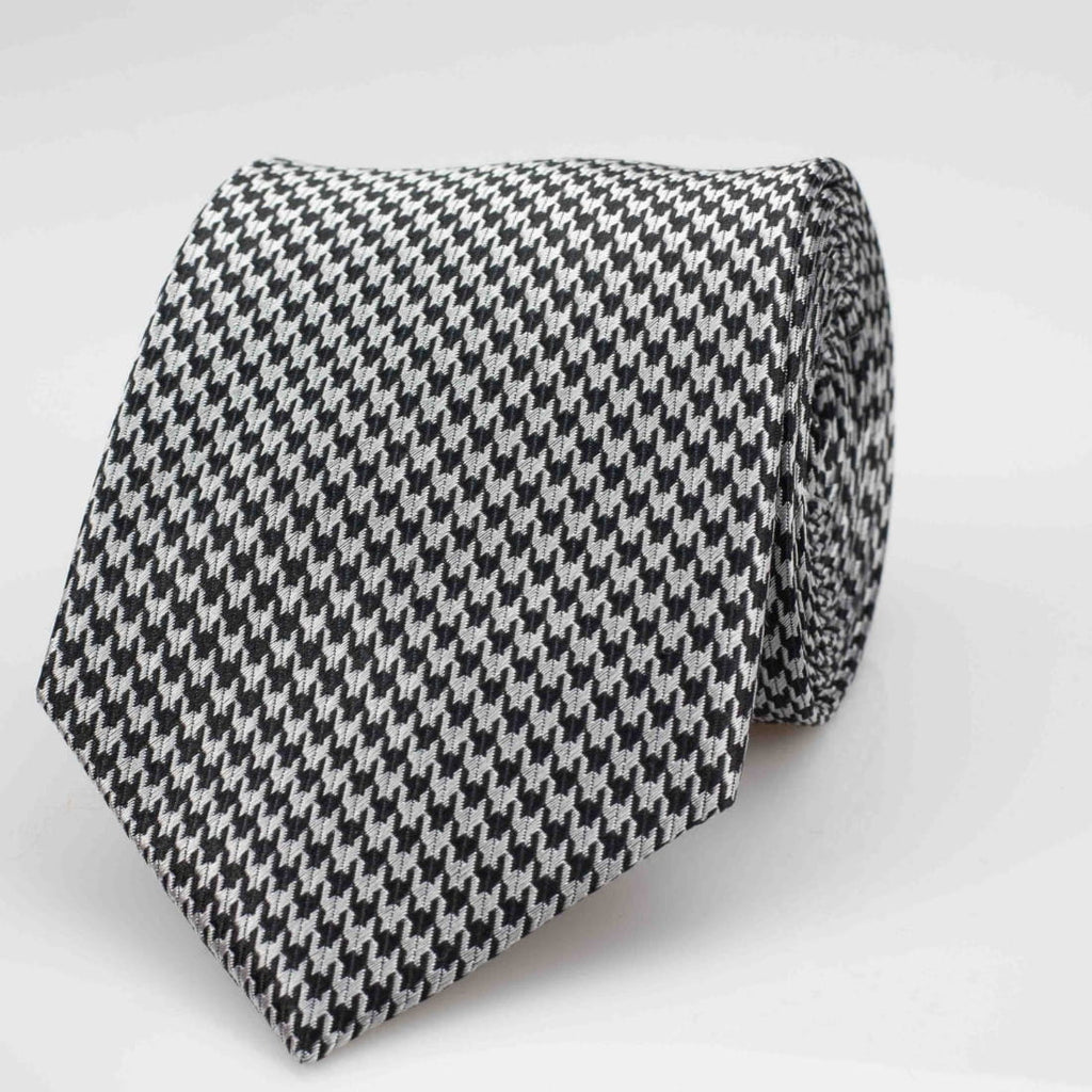 Black and white houndstooth patterned tie on a light gray background