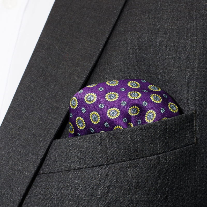 purple pocket square with yellow flower motif in jacket pocket