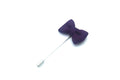 Purple bow tie pin on a white background