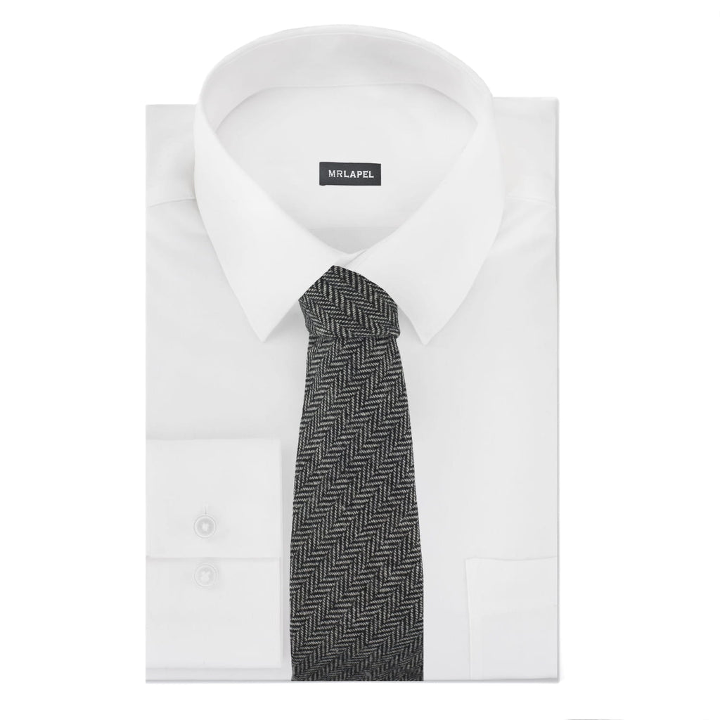 White dress shirt with a black and gray patterned tie on a white background