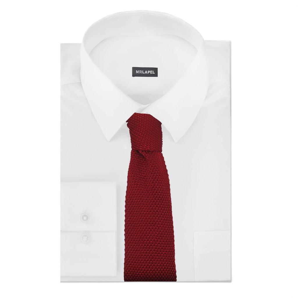 White dress shirt with a red knitted tie on a white background