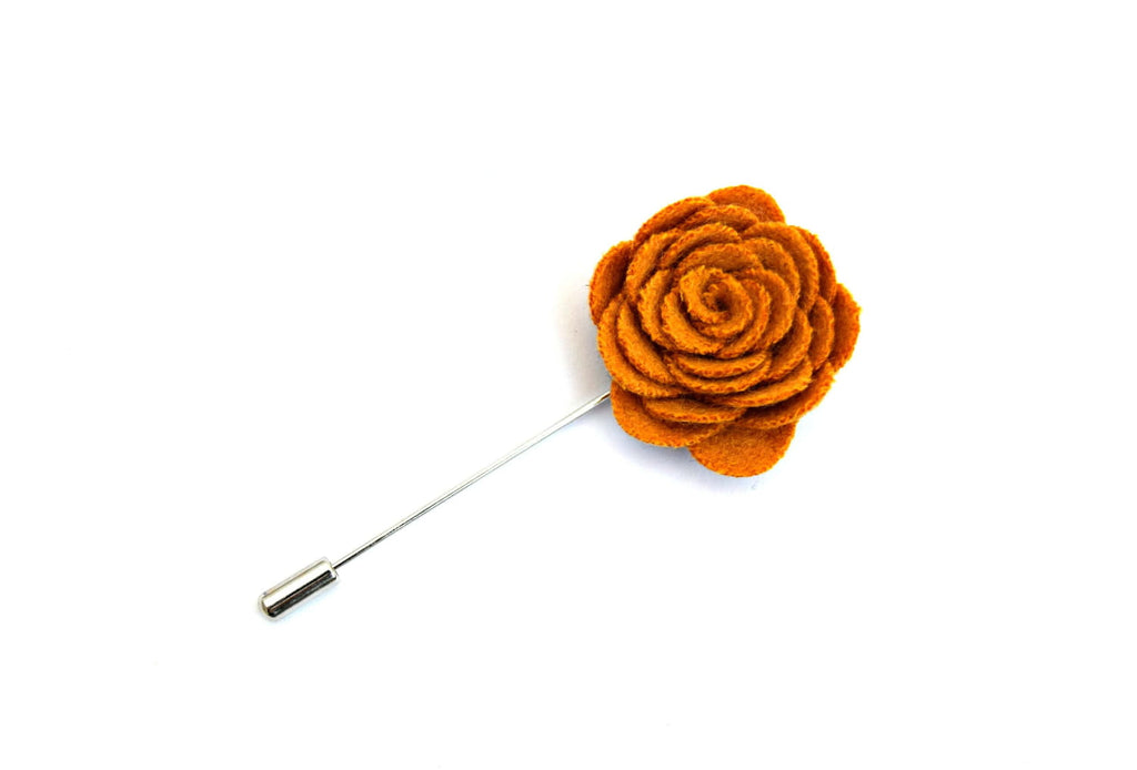 Orange flower lapel pin on a white background