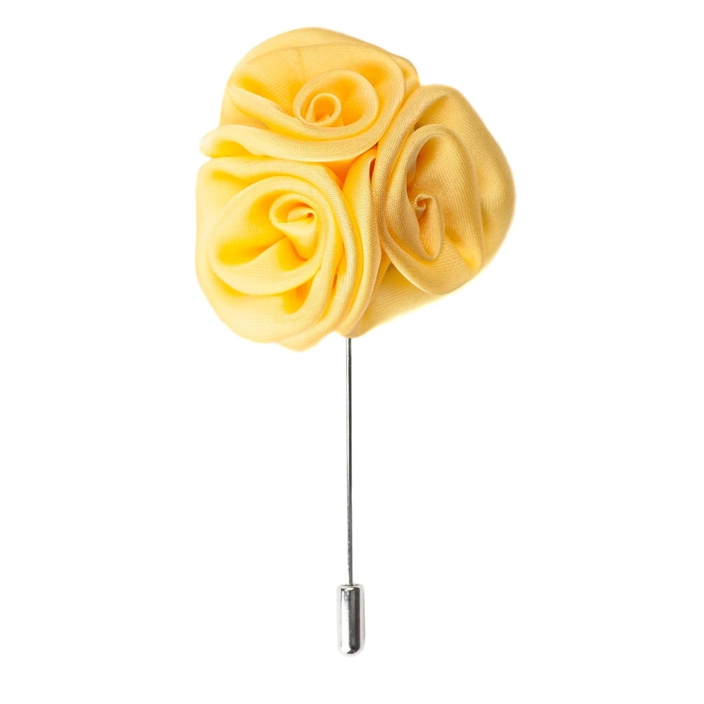 Yellow rose-shaped brooch on a white background