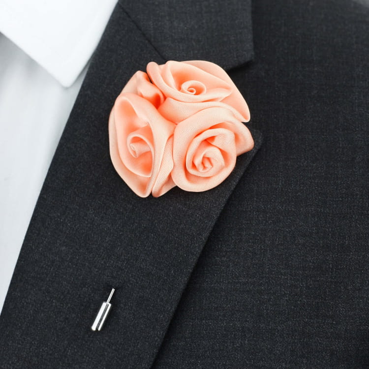 Pink rose brooch on a black suit jacket