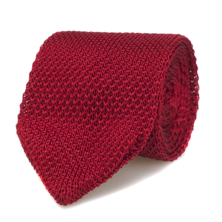 Red knitted tie on a white background
