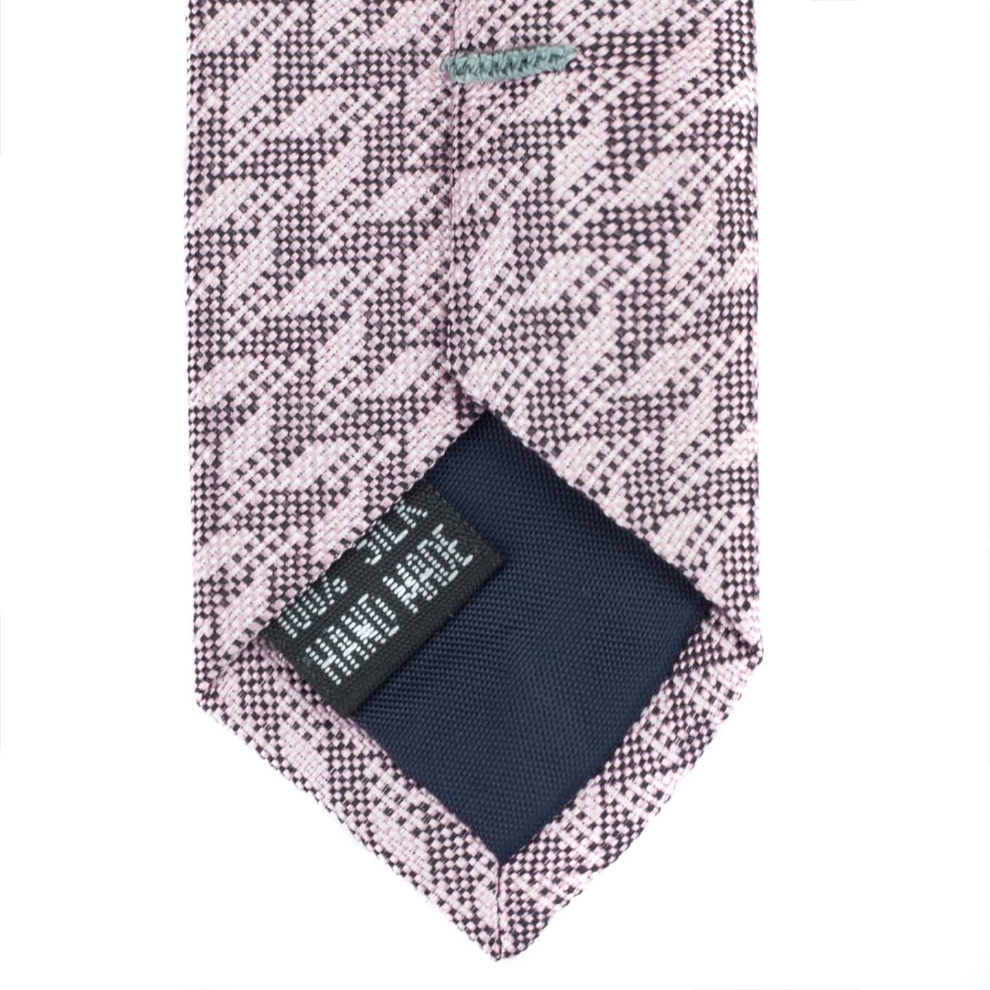 Patterned tie with a pocket square on a white background