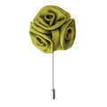 Green flower-shaped brooch on a white background