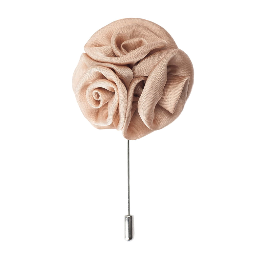 Beige flower-shaped brooch on a white background