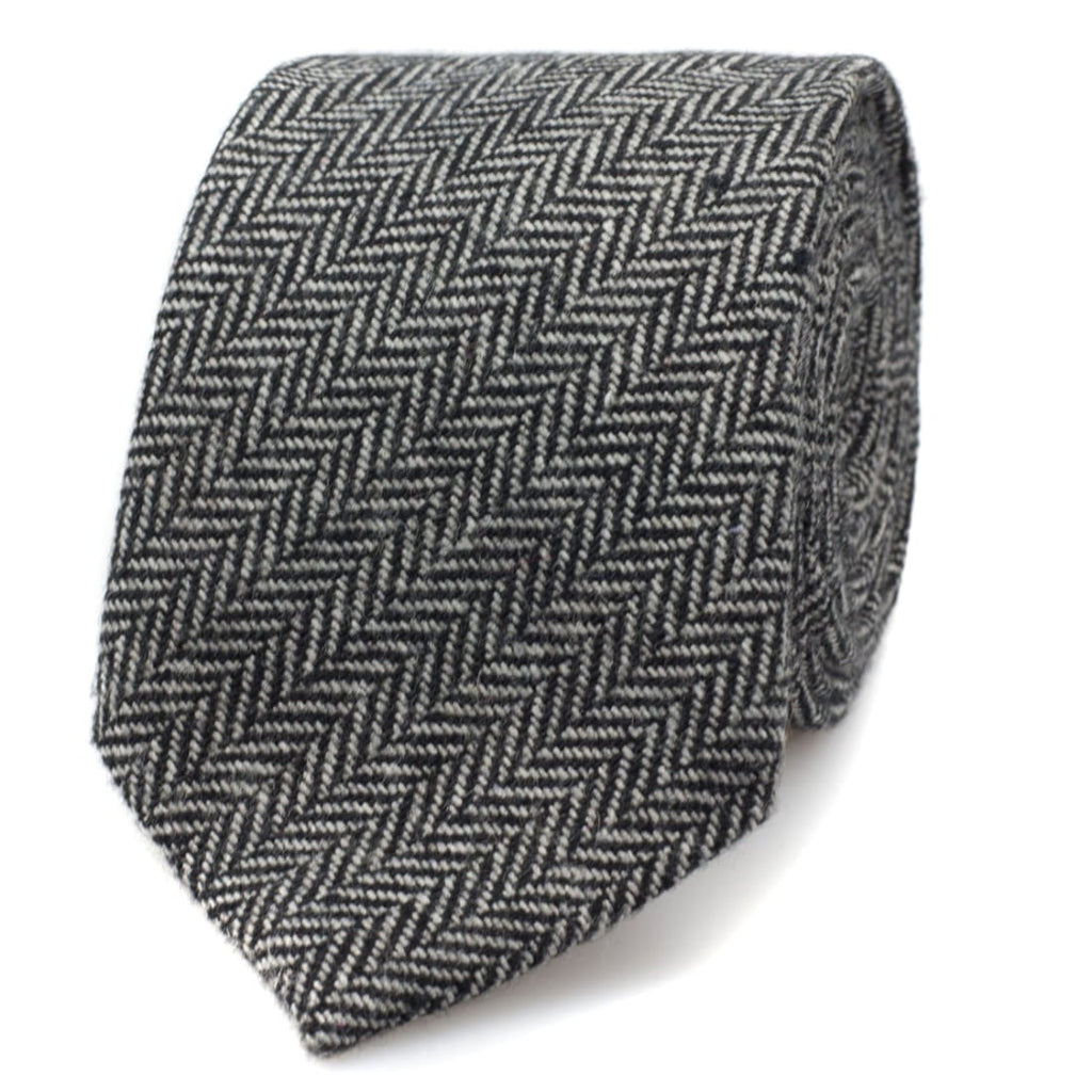 A grey herringbone tie against white backdrop