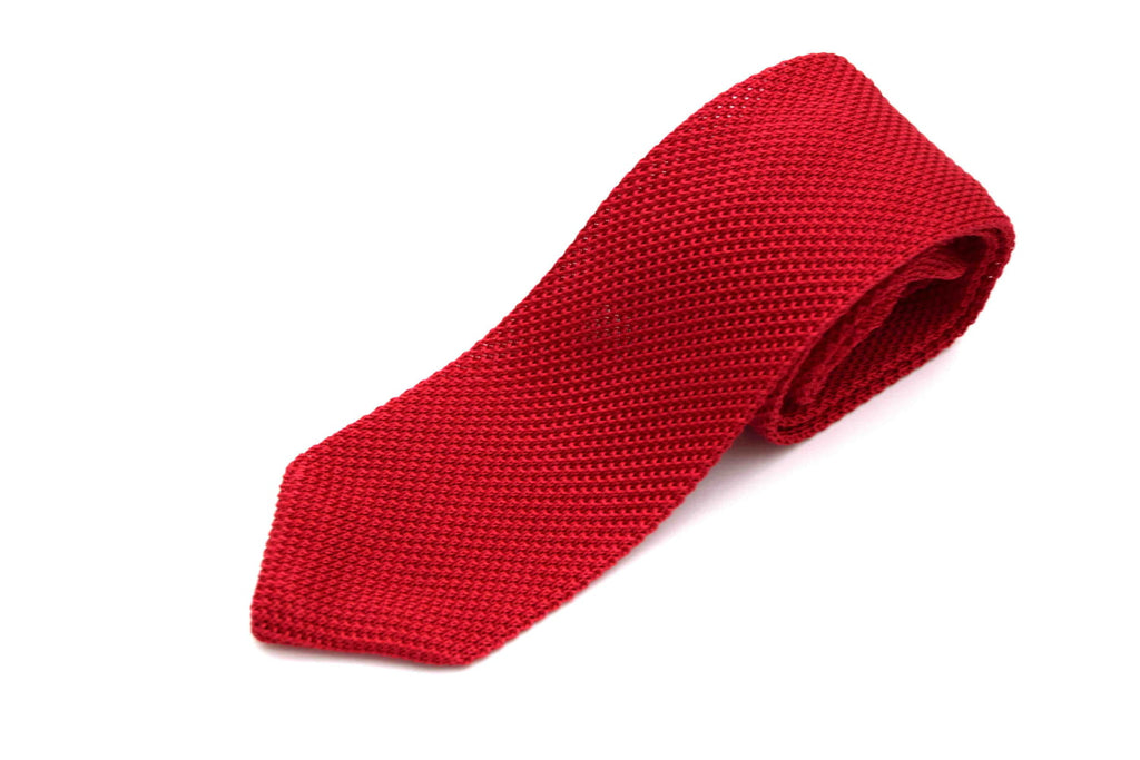 Red knitted tie on a white background