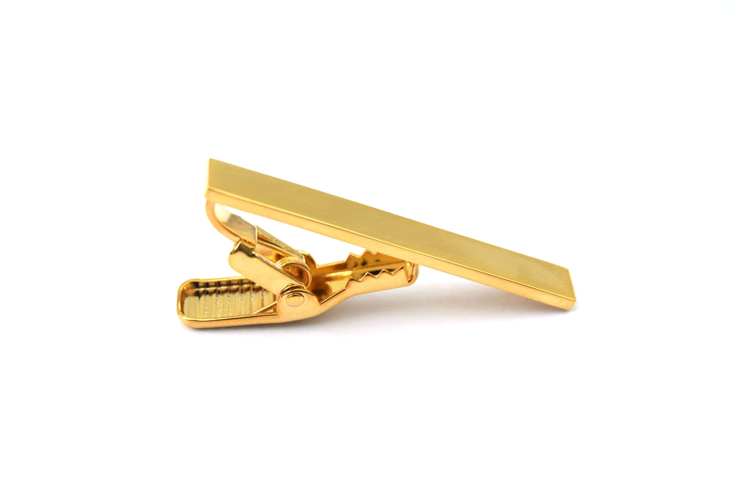 Gold tie clip on a white background