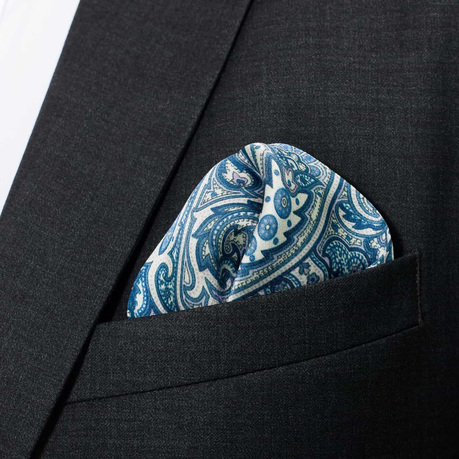 Blue paisley pocket square in a black suit jacket pocket