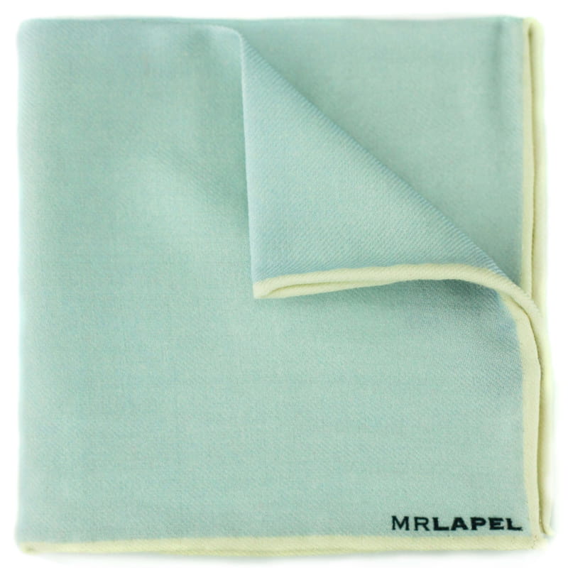 Folded light blue pocket square with cream border on a white background, featuring the brand 'MRLAPEL'.