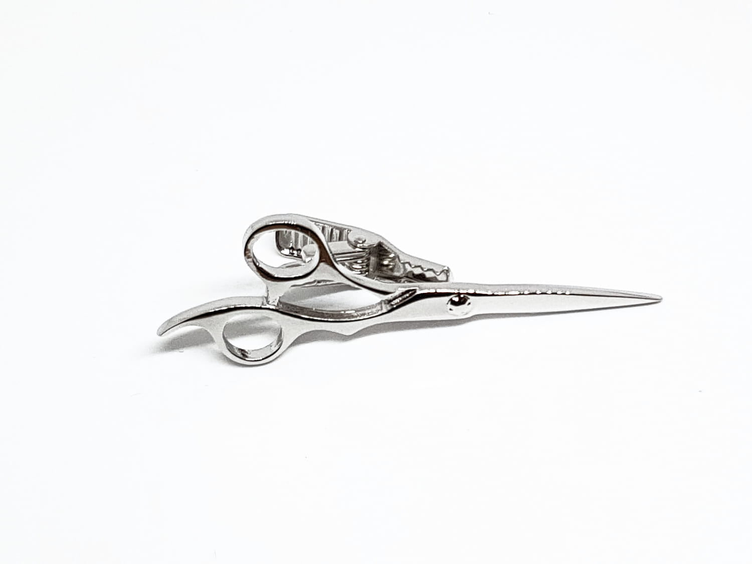 Silver scissors on a white background