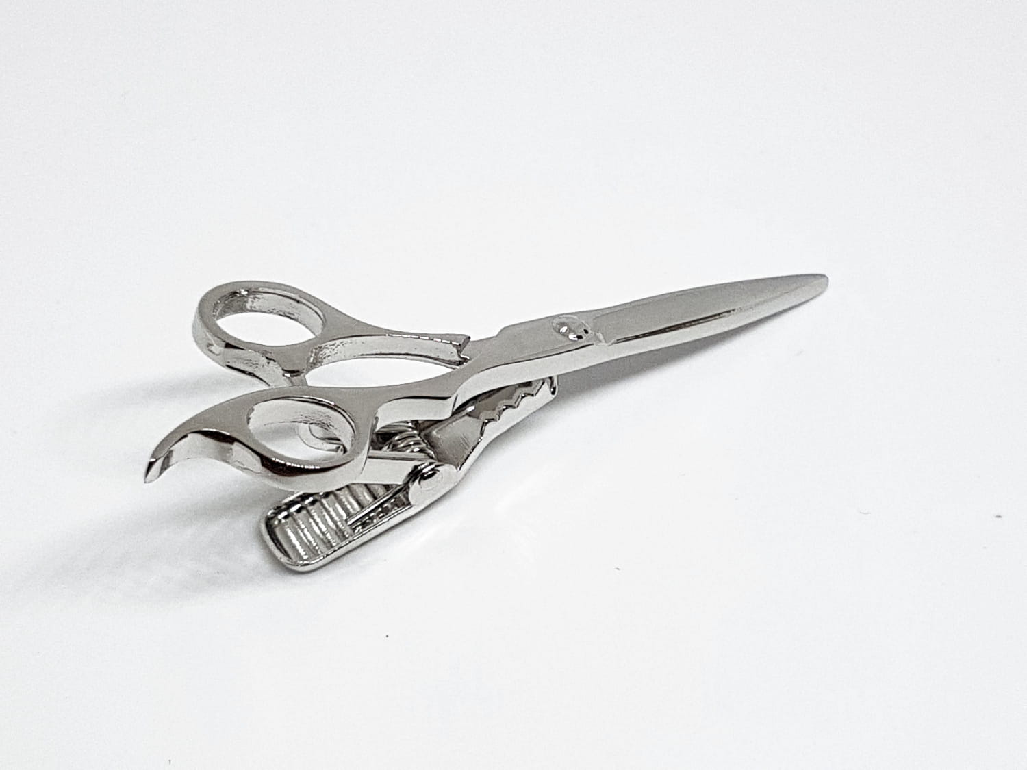 Metallic scissors on a white background
