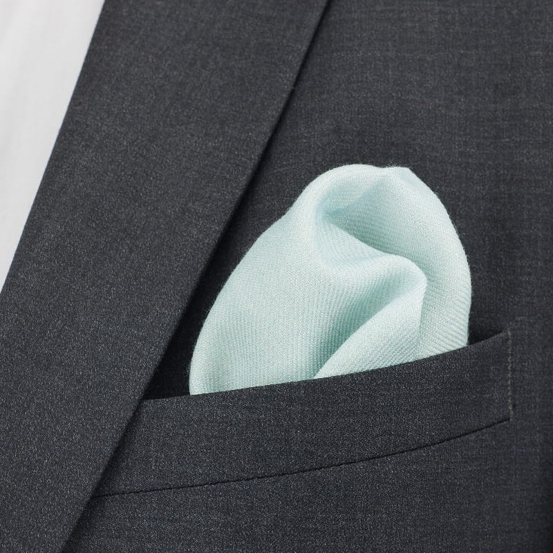 Light blue pocket square in a dark gray suit jacket