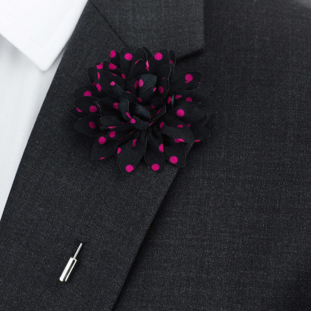 Black suit jacket with a black and pink polka dot flower lapel pin.