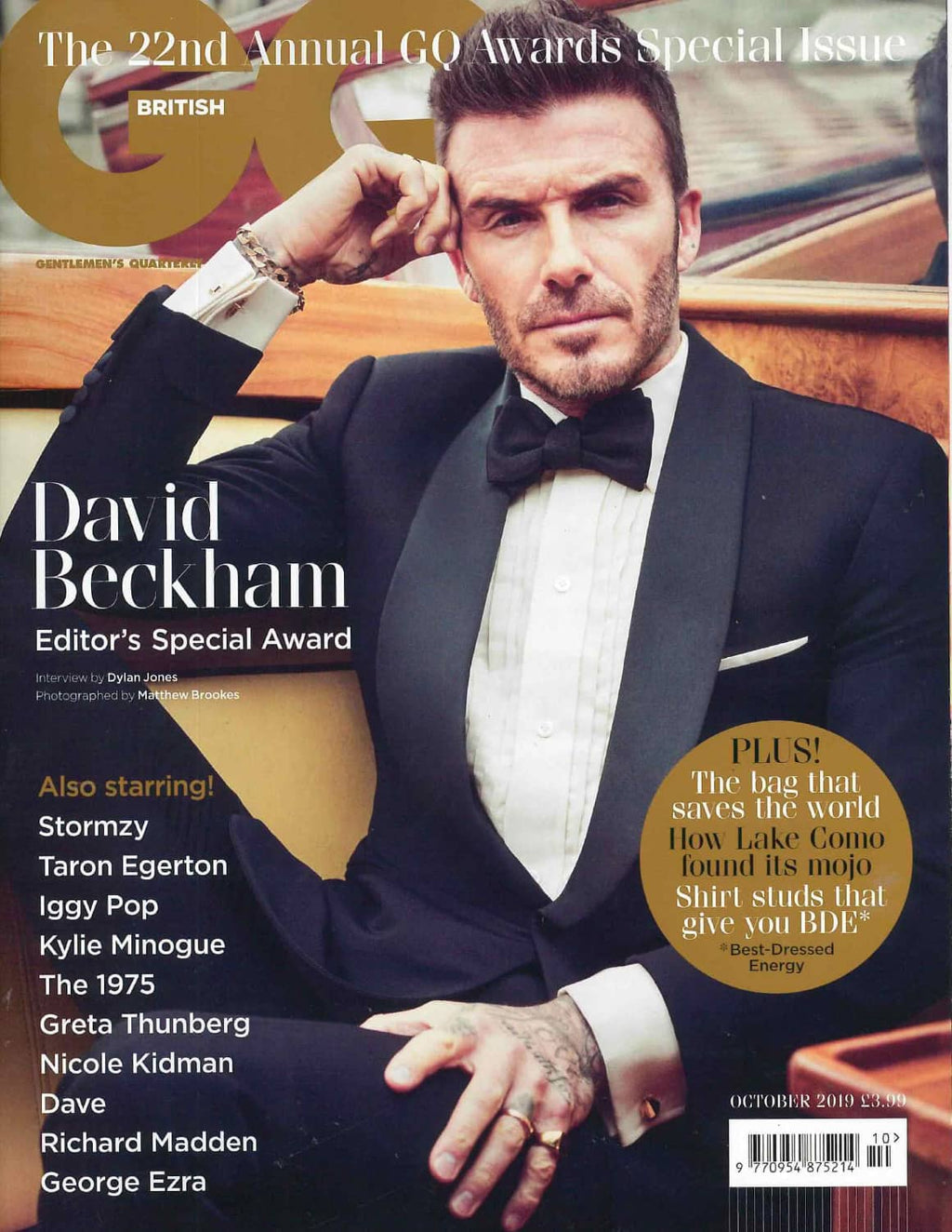 GQ magazine cover featuring David Beckham in a tuxedo with a car in the background