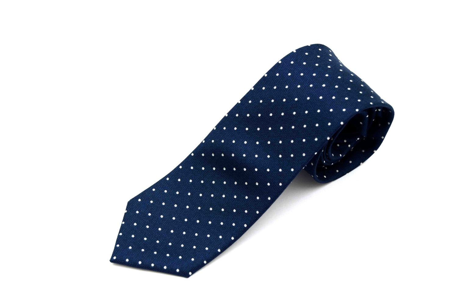 Navy blue tie with white polka dots on a white background