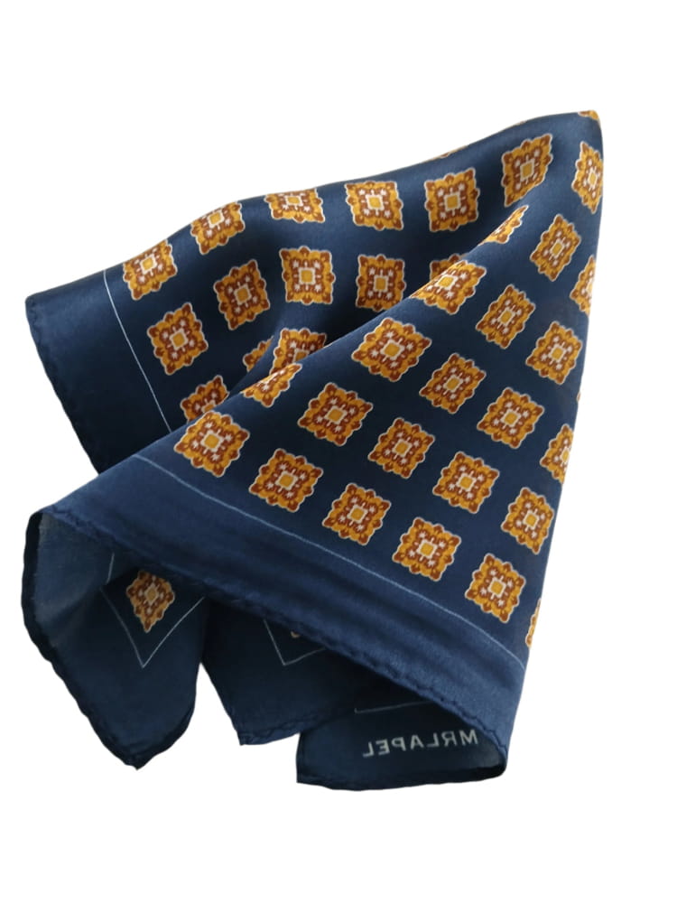 Navy blue pocket square with orange geometric pattern on a white background