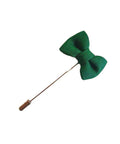 green lapel pin in the shape of a bow tie
