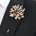 Brown and white floral lapel pin on a dark suit jacket