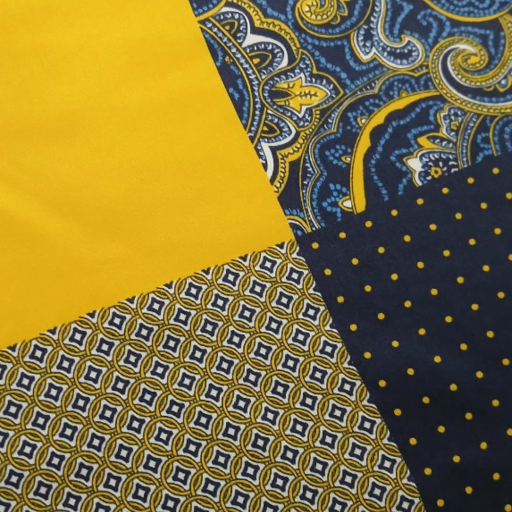 Four different fabric patterns in blue and yellow on a yellow background