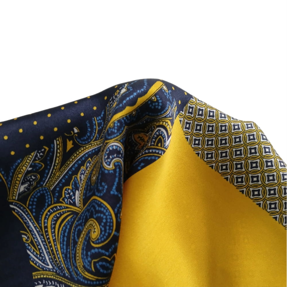 Close-up of fabric with blue and yellow patterns on a white background