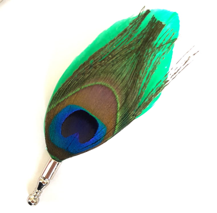 peacock feather lapel pin against white background