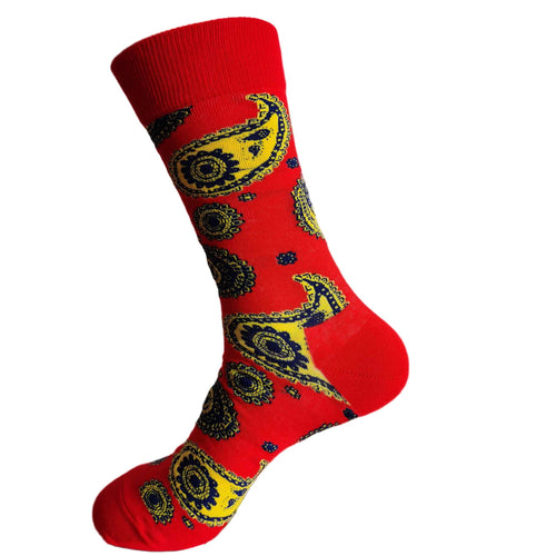 Red sock with yellow and black paisley pattern on a white background