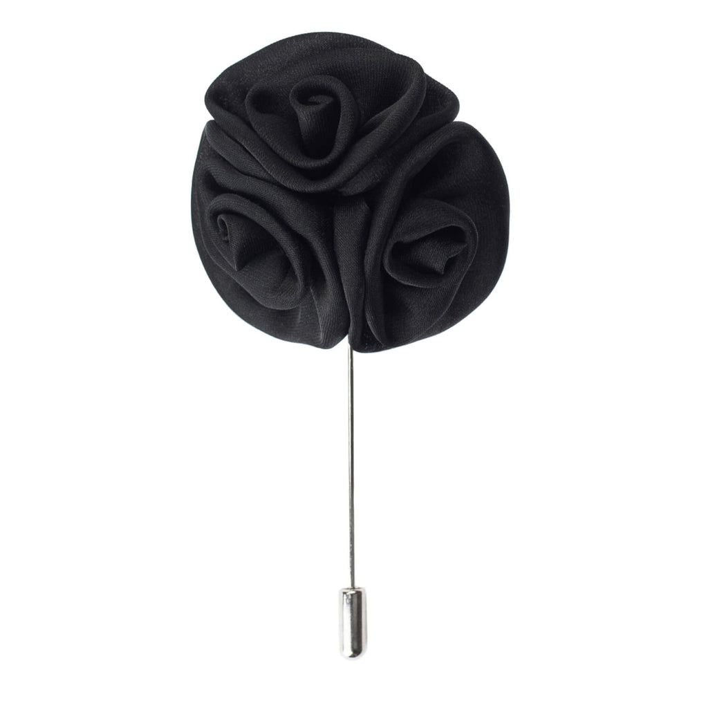 Black flower-shaped lapel pin on a white background