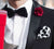 black bow tie with white pocket square and red lapel pin